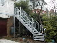 Galvanized Stairs Down from a Garden Balcony